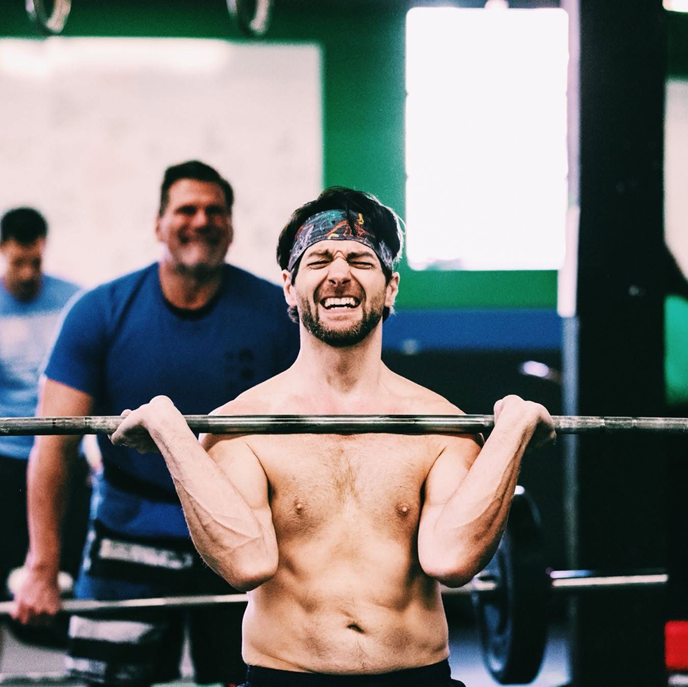 A masters athlete grinding through a heavy front-rack effort