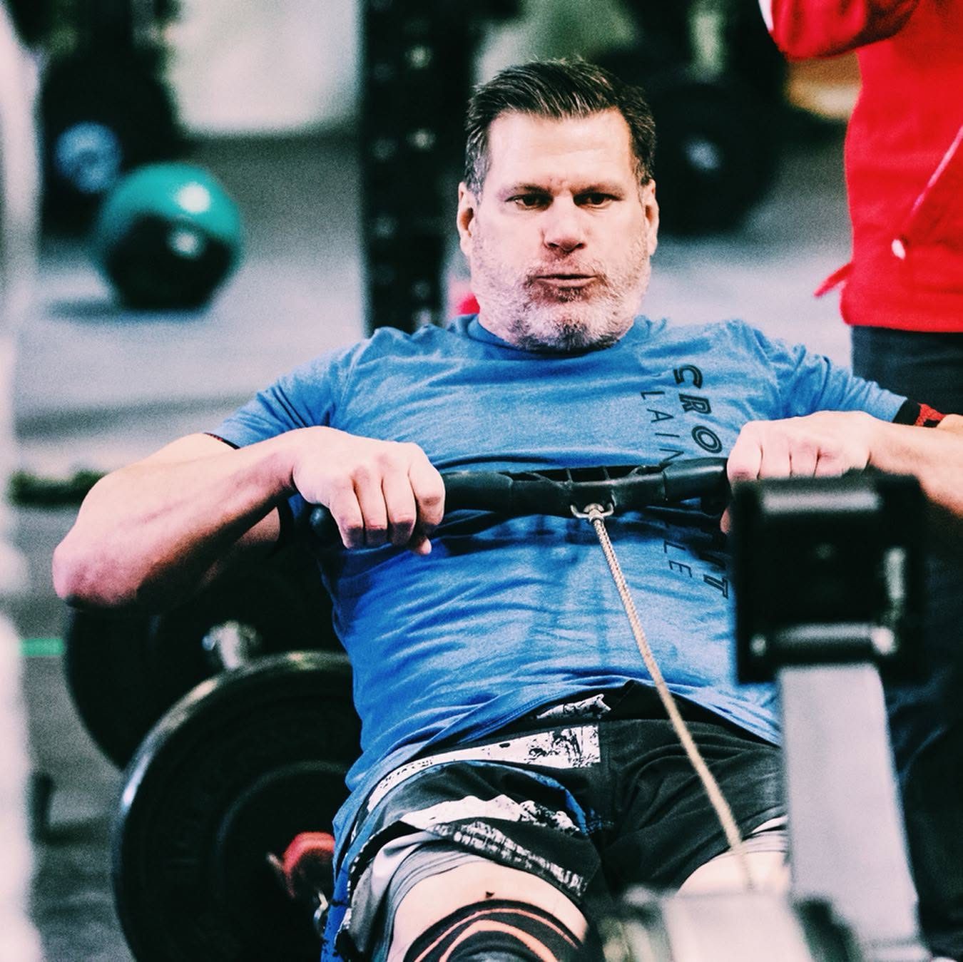 A masters athlete driving hard on the rower