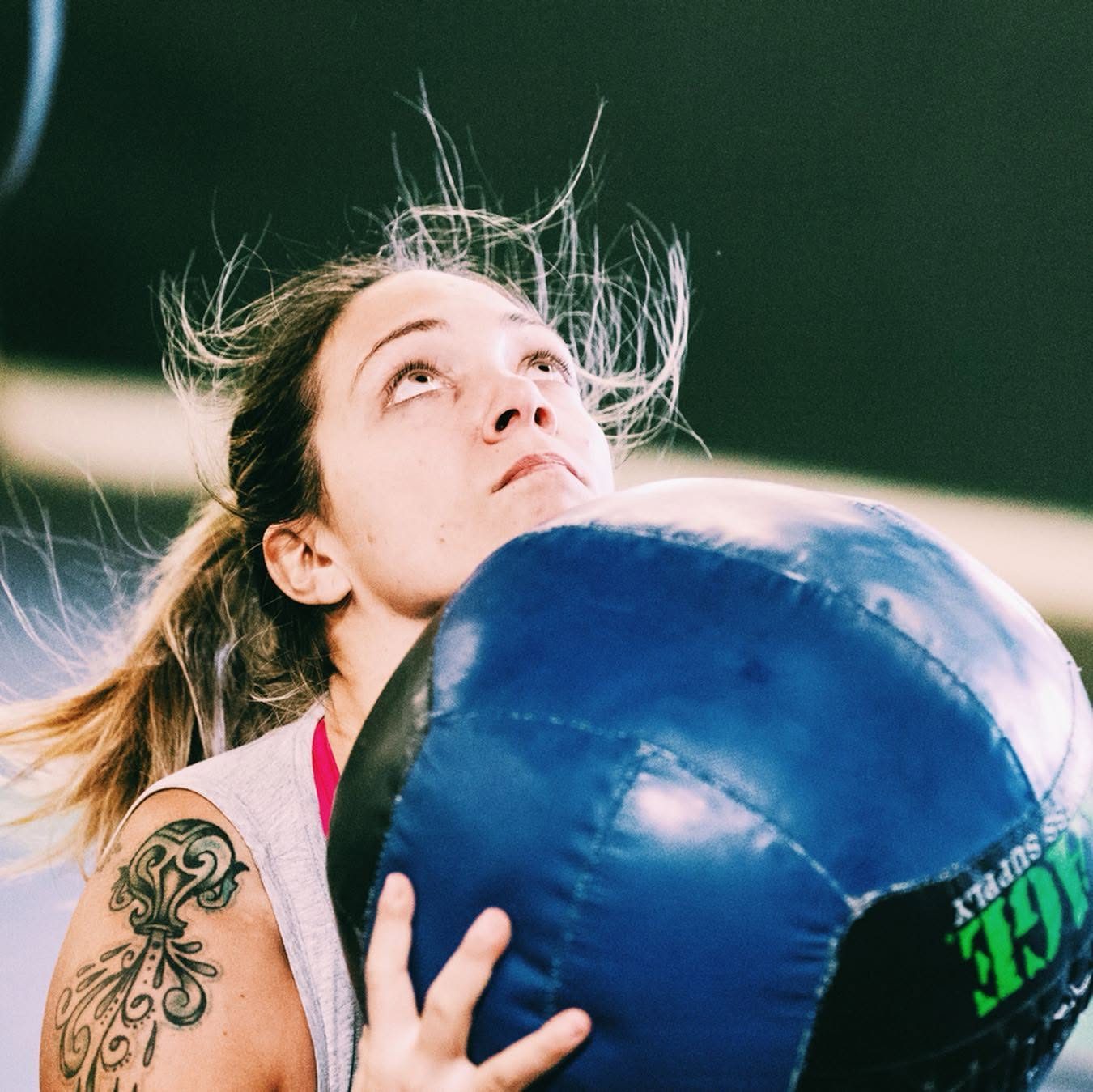 A masters athlete driving a wall ball overhead